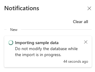 Snímek obrazovky s oknem oznámení, které indikuje, že se aktuálně importují ukázková data