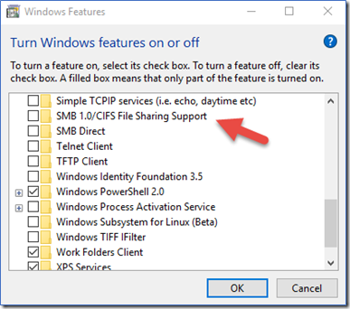 Screenshot of the Windows Features dialog. In the Turn Windows features on or off list, an arrow is pointing at SMBv1.