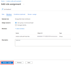 A screenshot showing the completed Add role assignment page and the location of the Review + assign button used to complete the process.