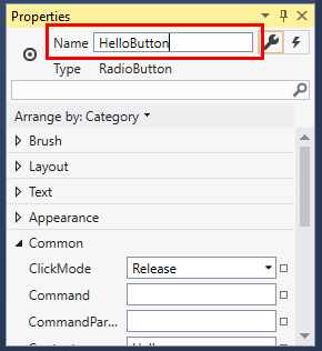 Screenshot of the Properties window for a RadioButton control with the value of the Name property changed to HelloButton.