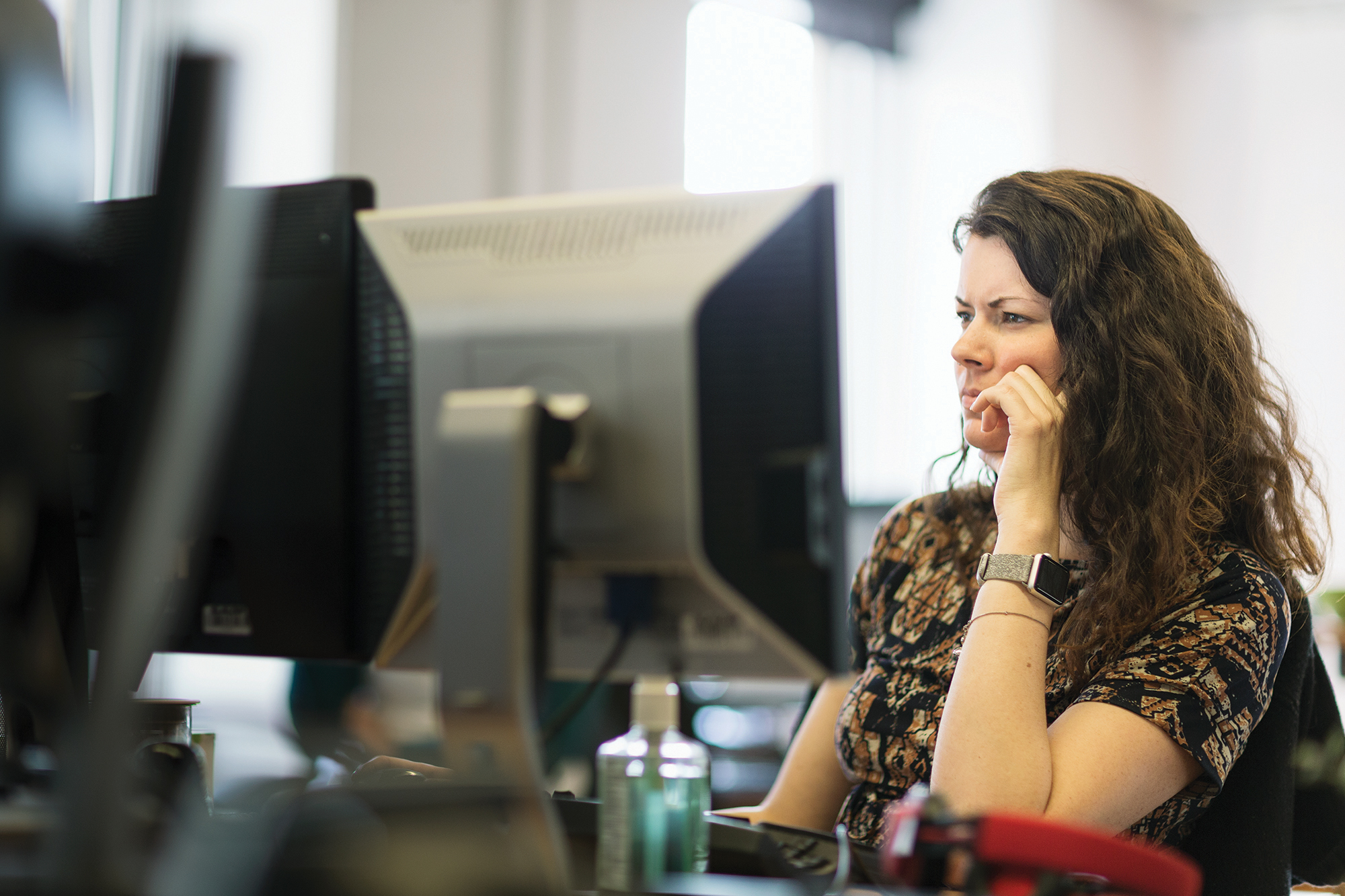 An information worker focuses on a screen.