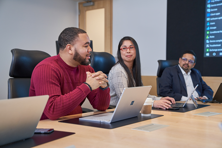 Coworkers sitting at a conference room table.