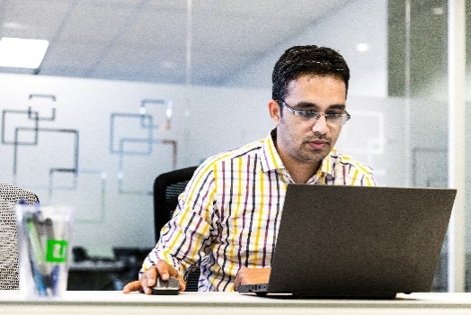 Man working on a laptop compnuter.