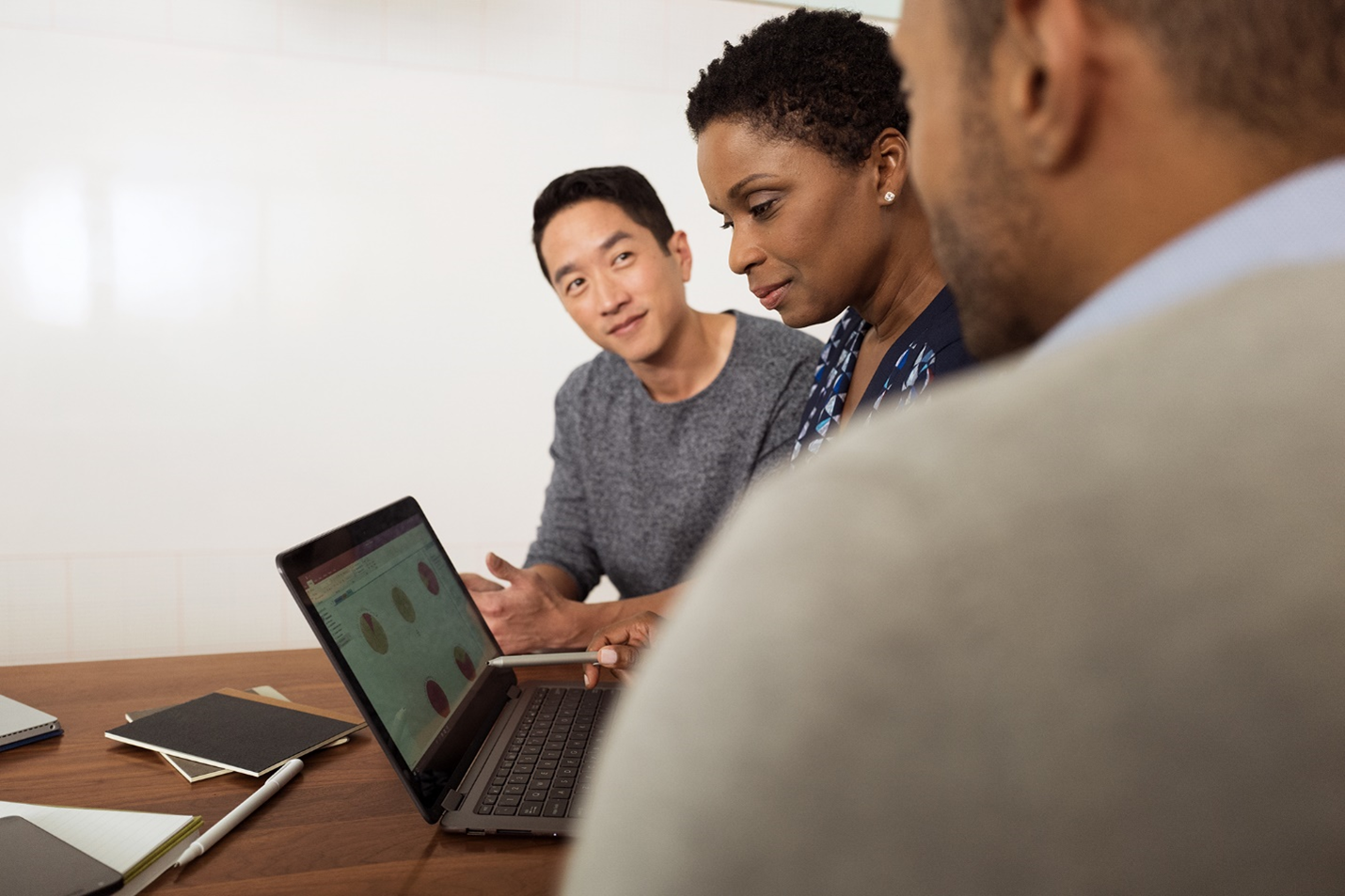 A photograph showing 3 people in meeting.