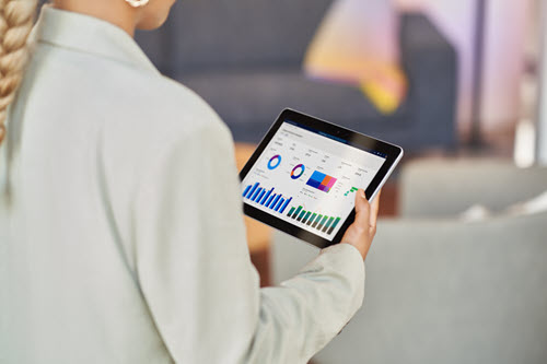 Photograph showing a person looking at a tablet.