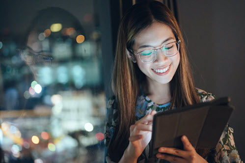 Photograph showing person looking at a tablet.