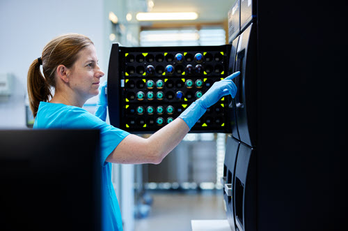 Photograph showing healthcare worker using a machine.