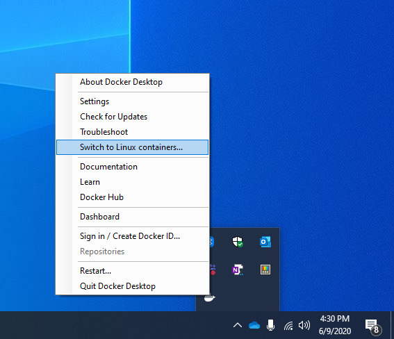 Docker system tray menu showing the "Switch to Windows containers" command.