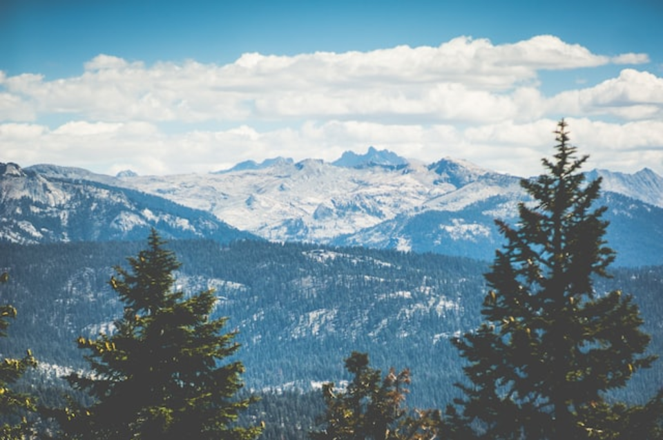 a picture of some mountains under a cloudy sky