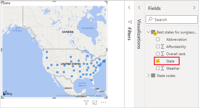 Captura de pantalla de Power BI Desktop en la que se muestra cómo se arrastra el campo State para crear una visualización de mapa.