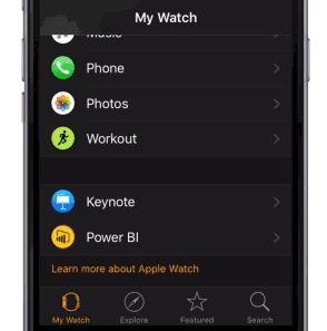 Photograph showing an iPhone with the My Watch app open and the Power BI icon visible.